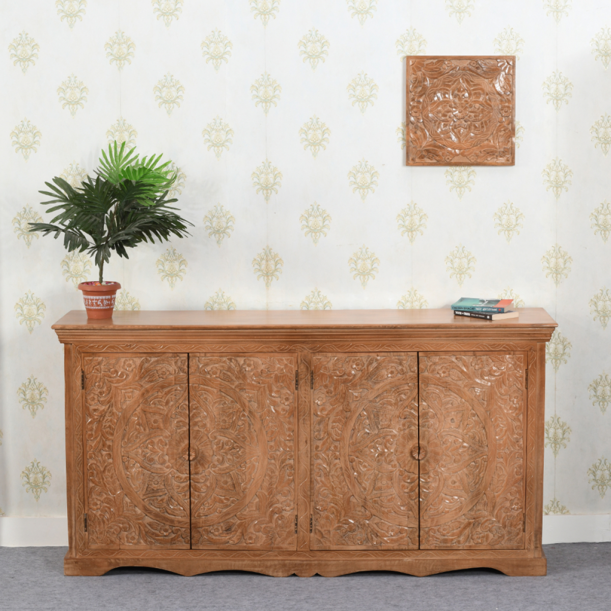 A warm honey-toned mango wood sideboard xl with intricate floral and circular carved patterns on four doors