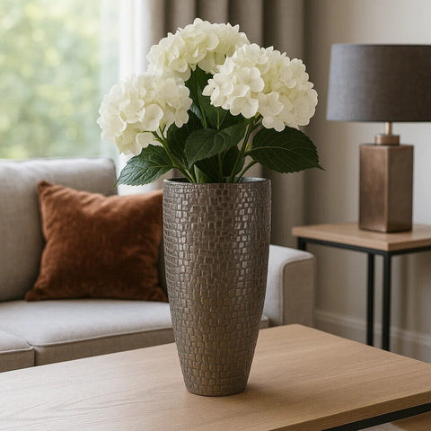 Tall textured gray ceramic arya pewter large vase holding a bouquet of white hydrangeas