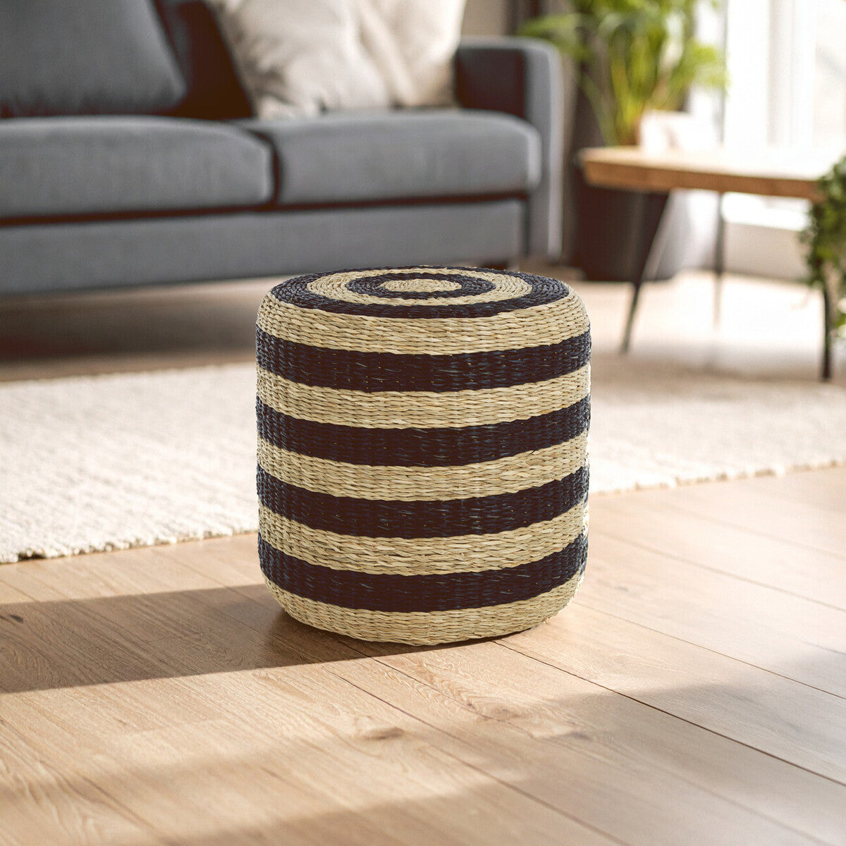 Ashby seagrass pouffe with black stripes made of tightly braided seagrass in dark brown and natural beige colors