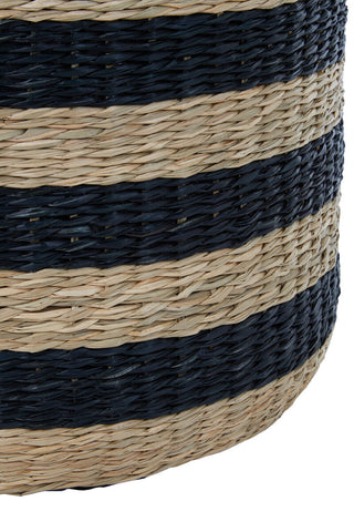 A cylindrical ashby seagrass pouffe with black stripes woven from natural beige and navy blue straw