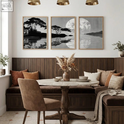 Marble-top round dining table with dark wood pedestal base paired with asian painting japanese moonrise silhouette wall art set in dining room