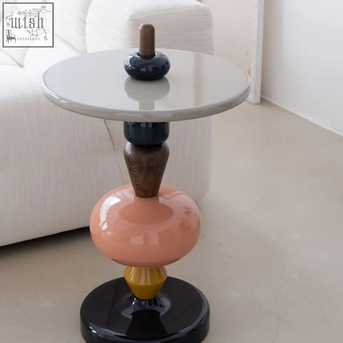 Aspasia side table with ash wood material features a glossy white top and stacked ceramic segments in peach black and mustard yellow