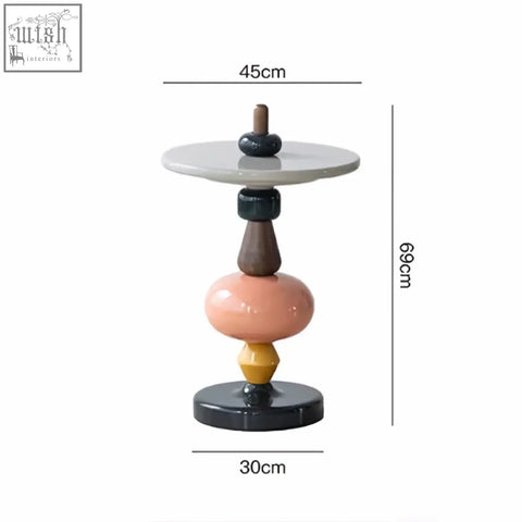 Aspasia side table in ash wood with a sleek gray top and stacked blush pink mustard yellow and dark brown wood material sections