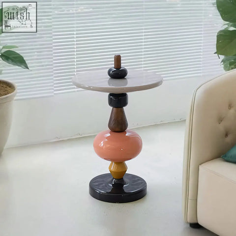 Aspasia side table with ash wood material features a marble top and geometric matte black and warm wood elements, clean with a damp cloth