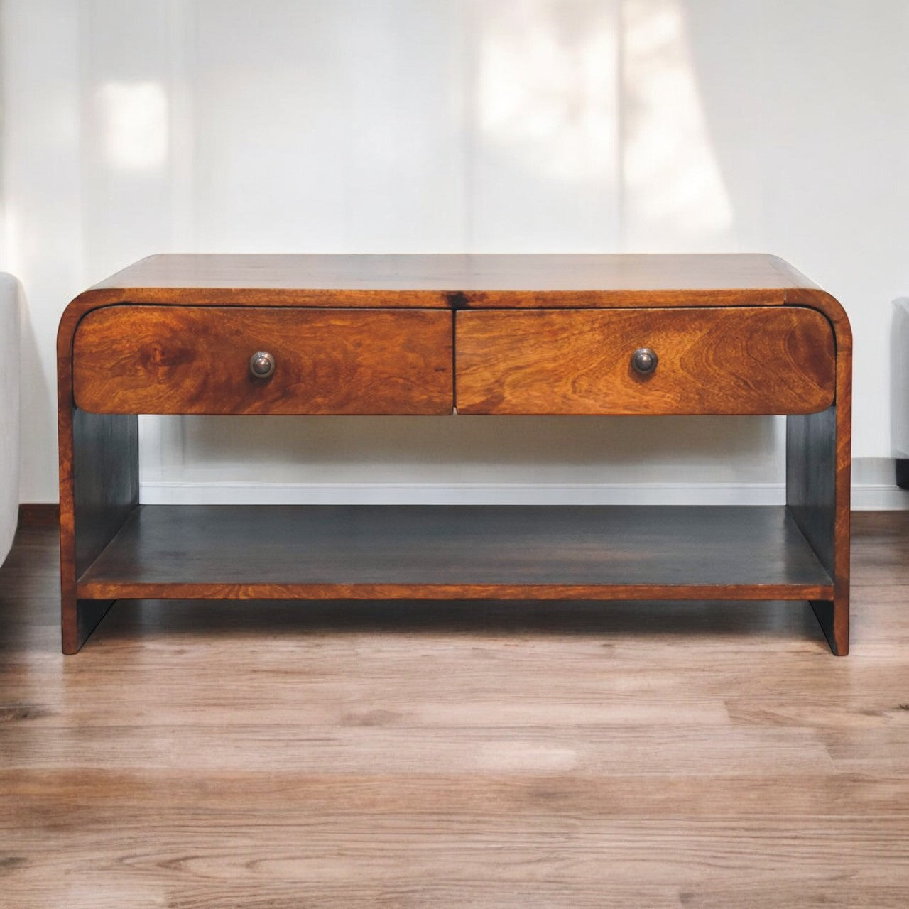A sleek wooden aspen slim coffee table with curved top two drawers and a lower shelf for extra storage