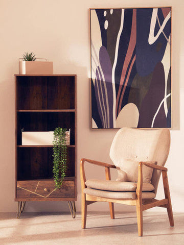 Beige upholstered armchair with wooden frame and hairpin legs beside astratto abstract multi wall art for living room