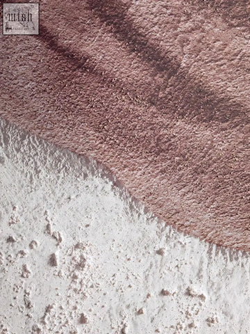 A soft pinkish brown earthy tones textured wall art with a subtle gradient blending into lighter speckled white area