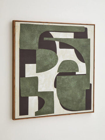 A square abstract wall art with layered green white and dark brown geometric shapes in a light wood frame
