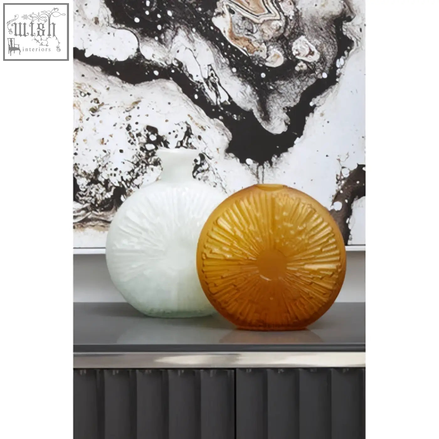 The amber-colored circular glass vase with sunburst etching is a unique natural wall art piece for any natural wall decor
