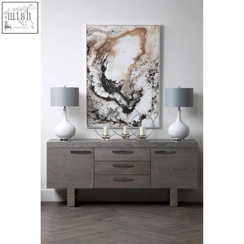 Gray wood console table with multiple drawers and sleek metal handles complementing natural wall art decor