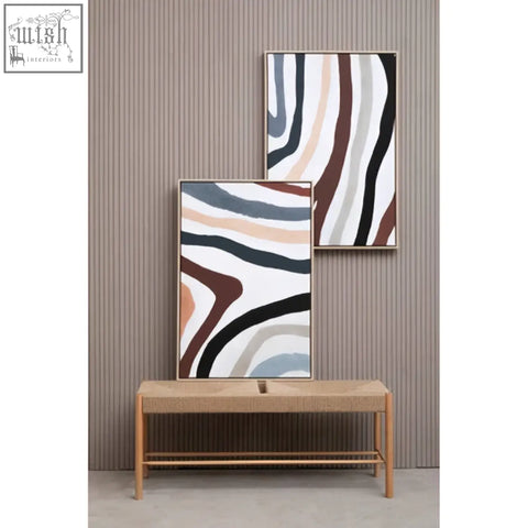 Two multi coloured abstract wall art prints with flowing wavy patterns in black white beige and muted brown tones displayed