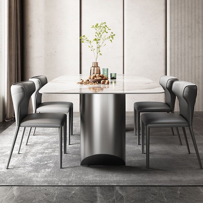Modern astrid dining table with sleek white sintered stone top and cylindrical metallic base with gray leather chairs