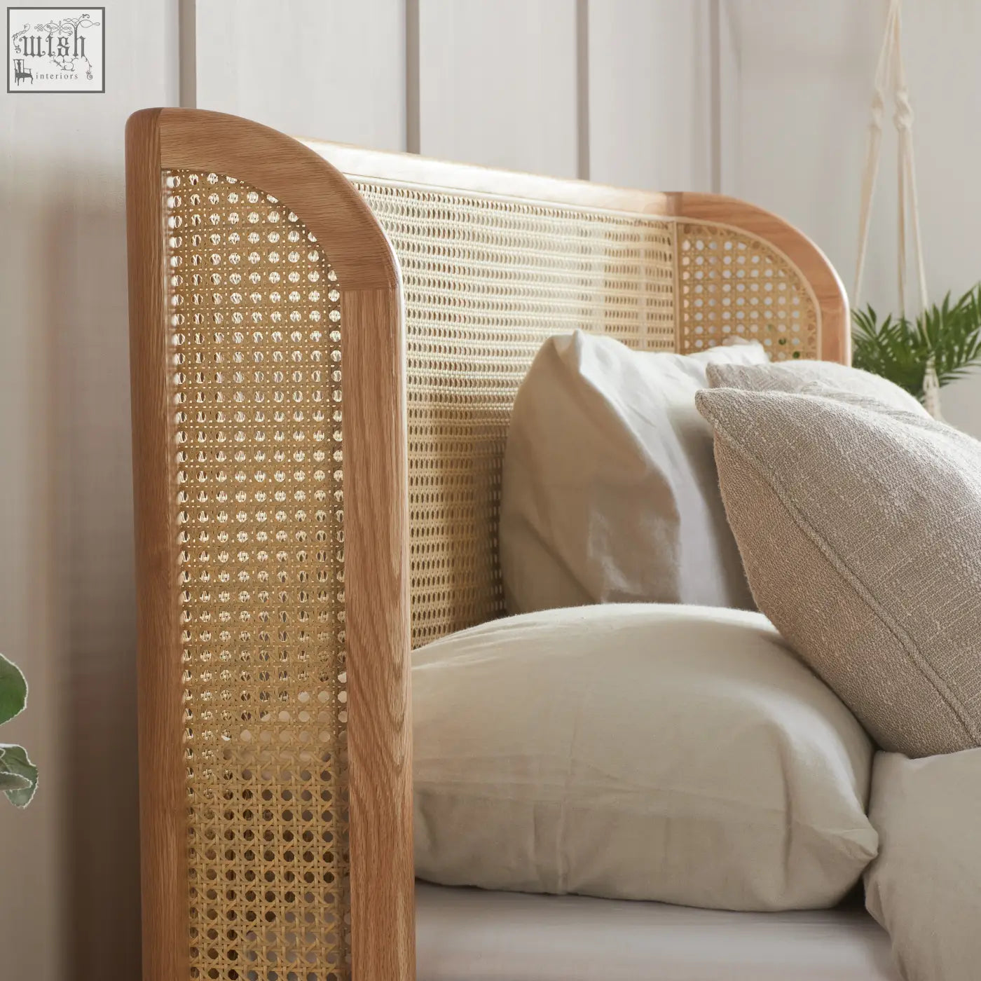 A light oak astrid rattan double size bed frame with a wood-framed woven natural-toned rattan headboard