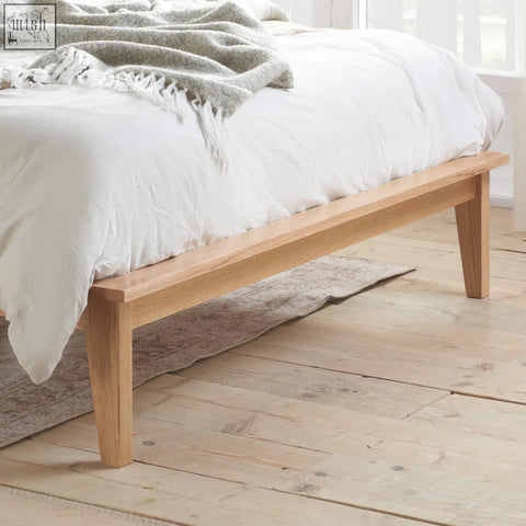 Light oak astrid rattan double size bed frame with clean lines and tapered legs in oak finish