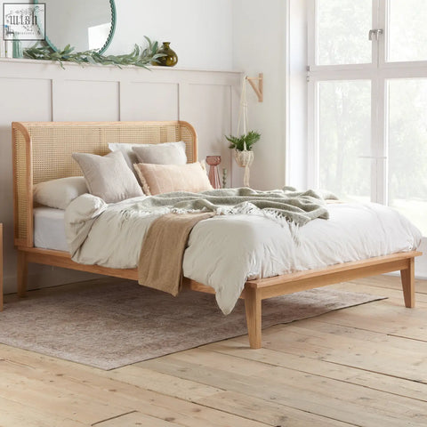 Light wood astrid rattan king size bed frame with woven cane headboard and matching legs in oak finish