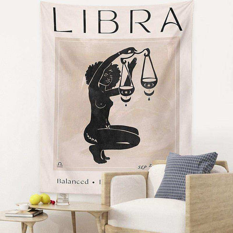 Beige astrology tapestry featuring a black libra goddess silhouette holding scales with libra and balanced text