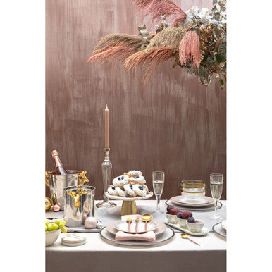 A delicate silver-toned dessert plate with a gold rim holding white and black frosted pastries for atholl ice bucket use