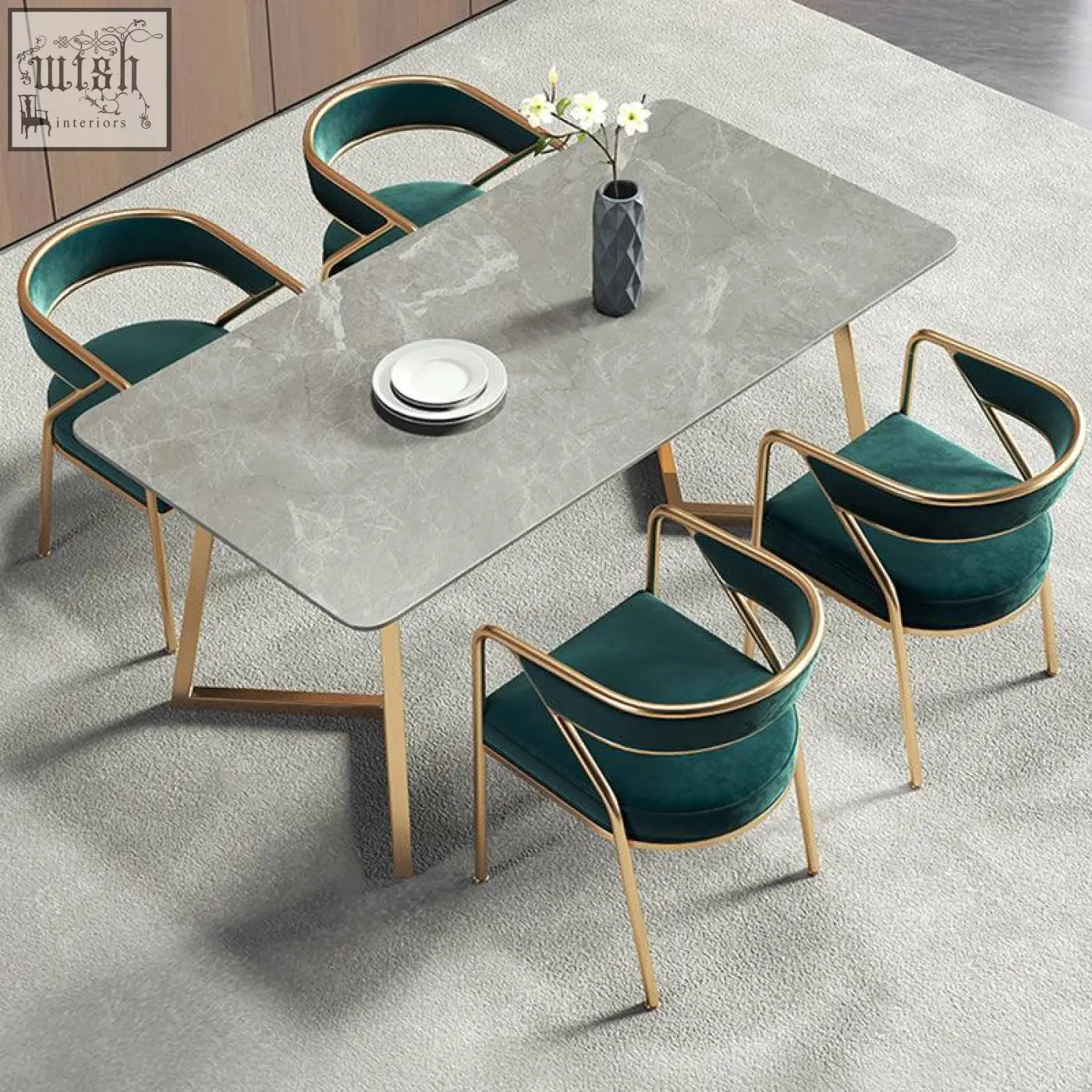 Modern attleboro dining chair with green velvet upholstery around gray marble dining table with gold legs