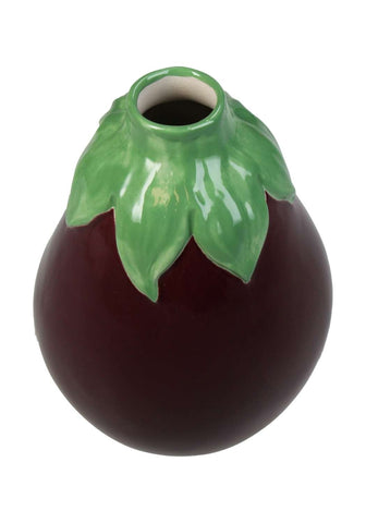 A glossy dark purple ceramic aubergine bud vase shaped like an eggplant with a vibrant green leafy stem