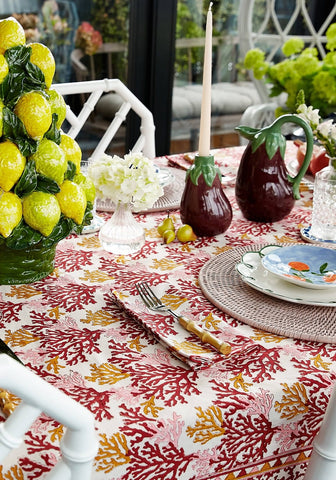 Aubergine dream candle holder displayed on a vibrant coral-patterned tablecloth with red pink and gold hues