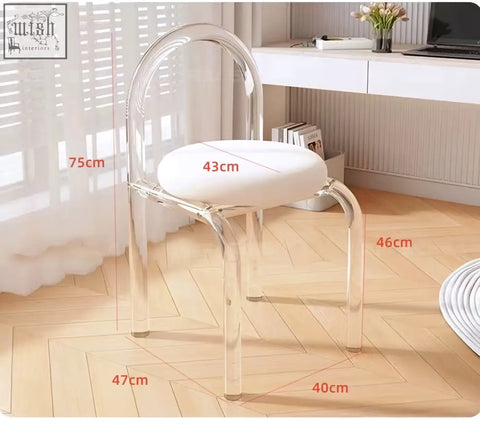 Clear acrylic chair with white upholstered seat part of aubrey cream dressing table set with side drawer