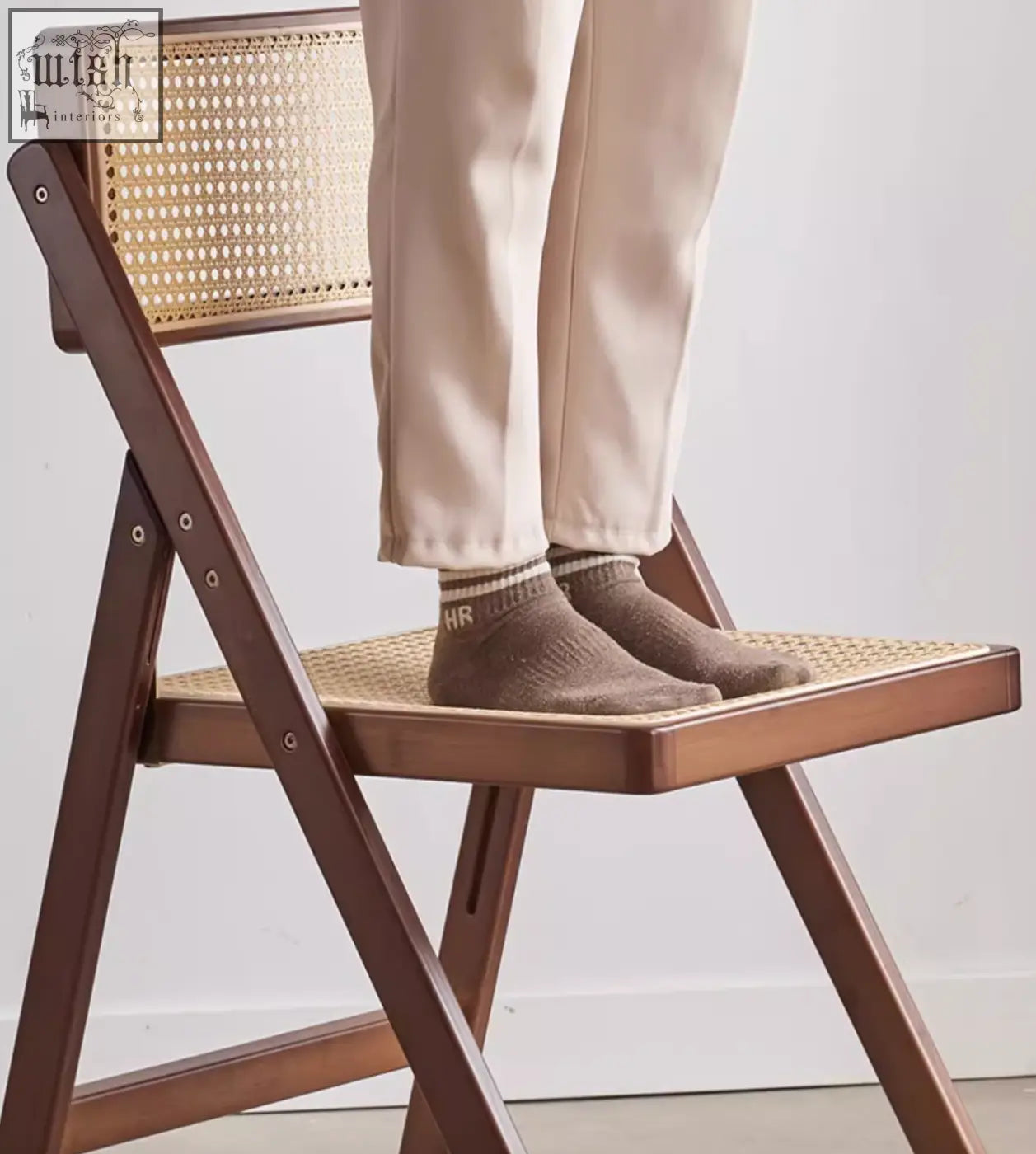 Brown wooden audrey folding dining chair with woven rattan cane seat and backrest perfect for dining areas