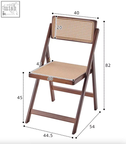 A dark brown audrey folding dining chair with a folding wooden frame and woven rattan seat and backrest