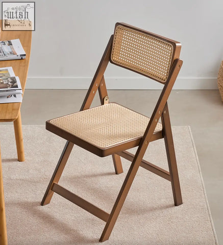 Audrey folding dining chair with warm brown wooden frame and woven rattan seat perfect as folding dining chair