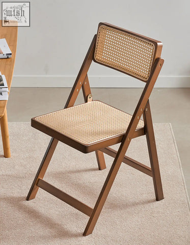 Audrey folding dining chair with sleek wooden frame and woven rattan seat in warm brown finish perfect as dining chair