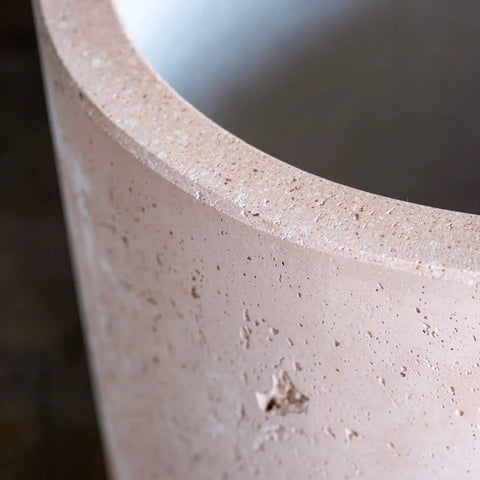 A beige blushstone colourway concrete cylinder planter with smooth rounded edges that works beautifully on kitchen counters