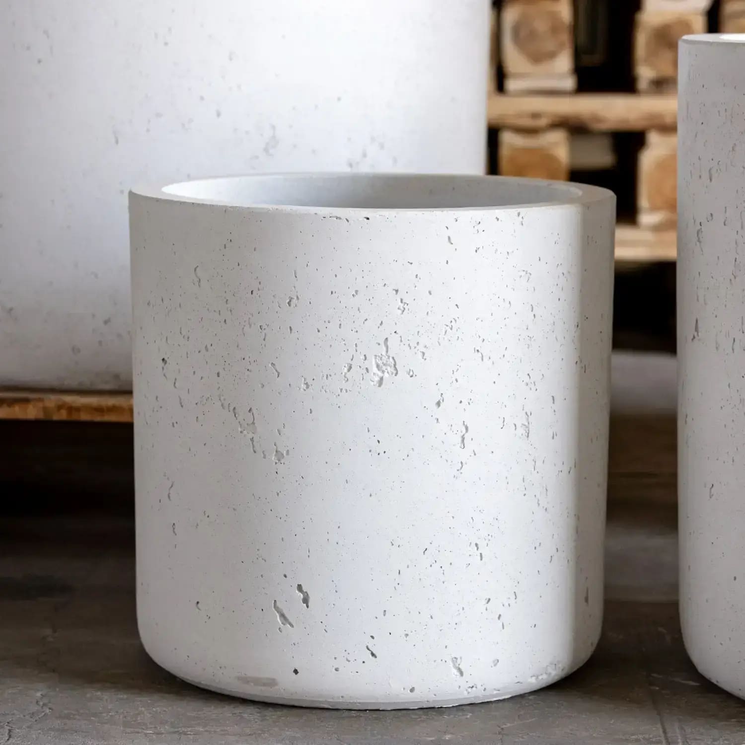 Aurella white mist 20cm medium concrete cylinder planter with matte finish and subtle speckled pattern to catch excess water on kitchen counters