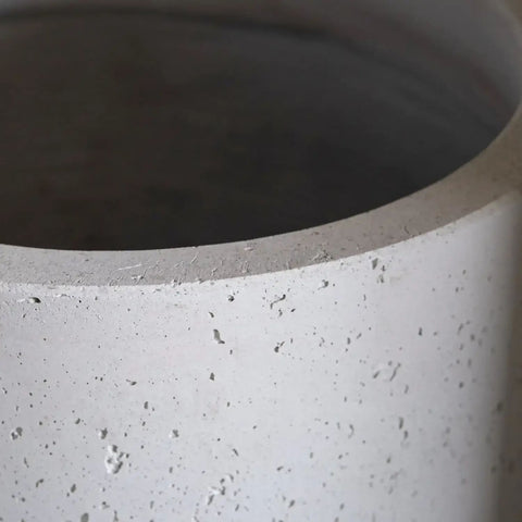 A white mist aurella 20cm medium concrete cylinder planter with speckled texture and rim to catch excess water on kitchen counters