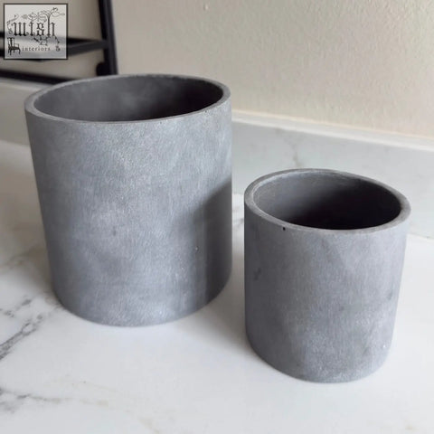 Two matte gray brushed grey stone resin plant pots in cylindrical shape indoor use, one larger one smaller