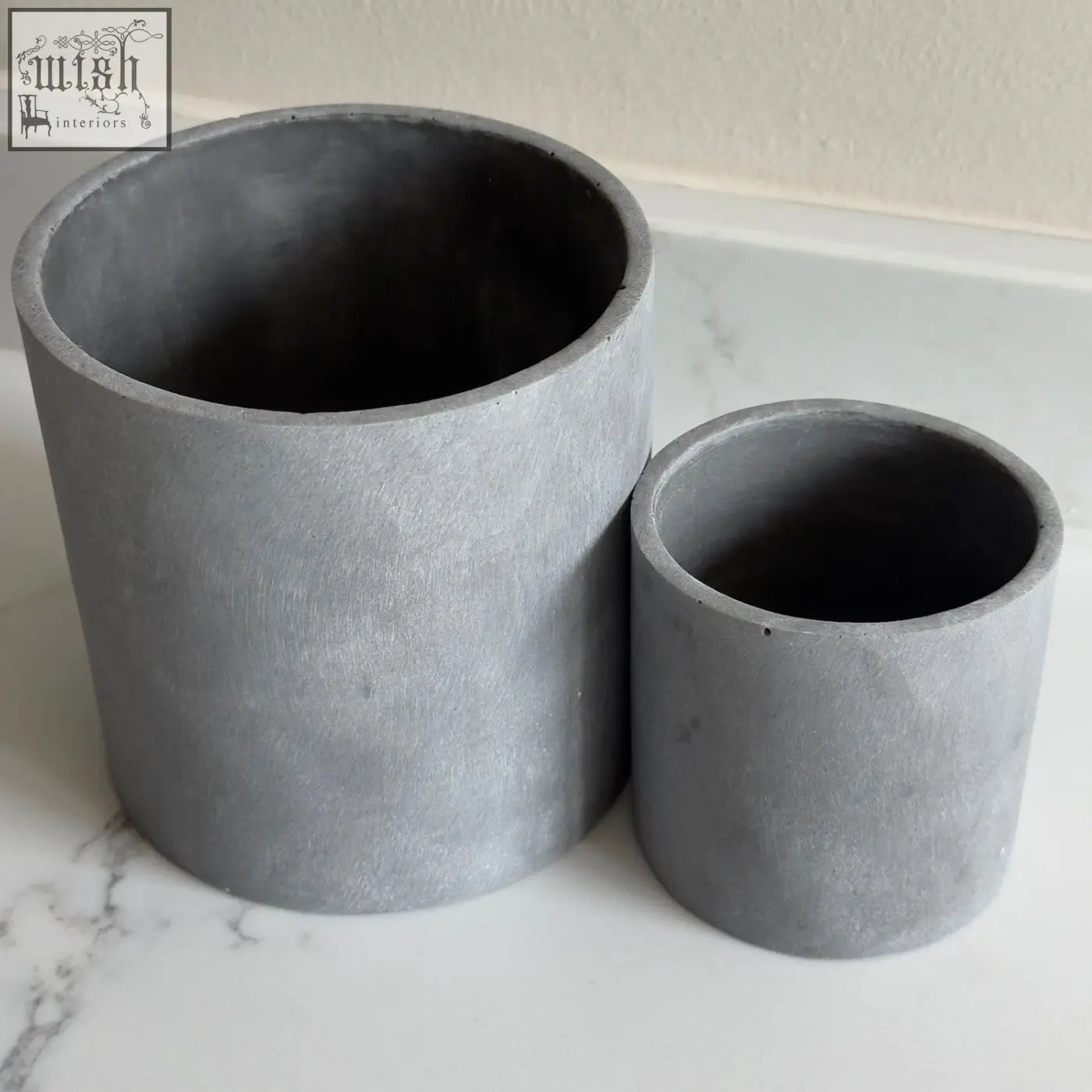 Two matte gray brushed grey stone resin plant pots with textured surface in a set of two for indoor use