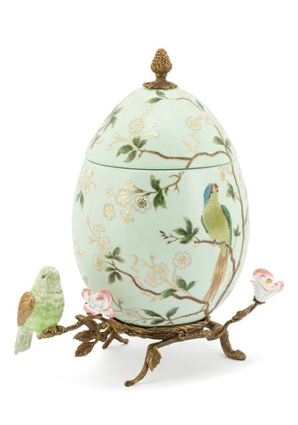 Delicate mint-green porcelain egg box with hand-painted birds and blossoms golden pineapple finial on bronze stand