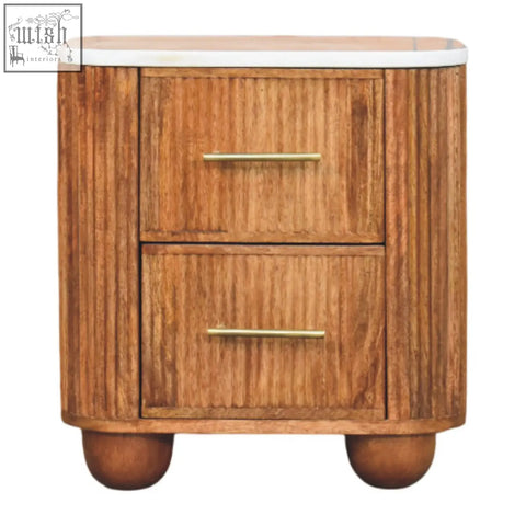 A sleek aurora marble bedside table with two drawers in warm marble-effect solid mango wood and ribbed sides