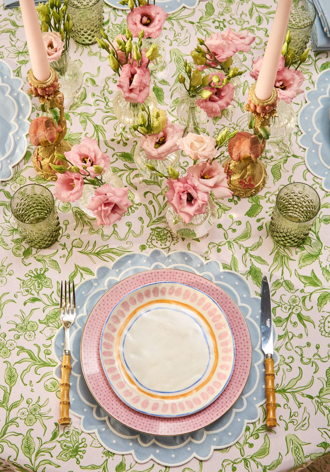 A delicate light blue aurora set of 4 placemats with pink and blue layered scalloped edges and a white center circle
