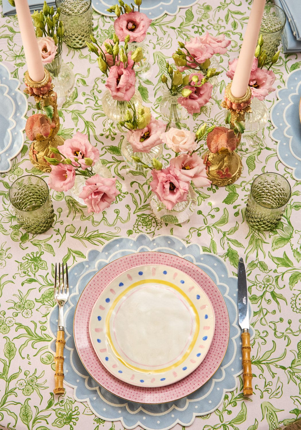Aurora set of 4 light blue scalloped edge placemats with a pastel pink and blue design and a white ceramic polka dot plate