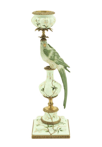 Aurora songbird candleholder right features an ornate white porcelain base with gold accents and a green parrot topper