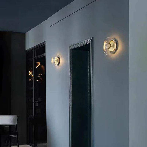 Gold-toned aurora wall lamp with clear glass diffuser and circular design modern wall lamp for ambient lighting