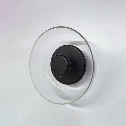 Clear glass vase with sleek black metal base as part of the modern aurora wall lamp design for stylish wall lighting