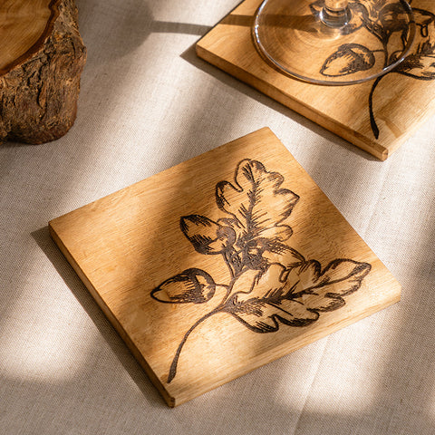 Square wooden oak coaster with dark brown autumn acorns engraved design perfect for fall decor