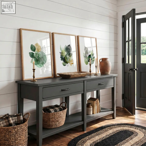 Dark gray painted console table with two drawers and rustic wooden top below autumn art botanical leaf three prints