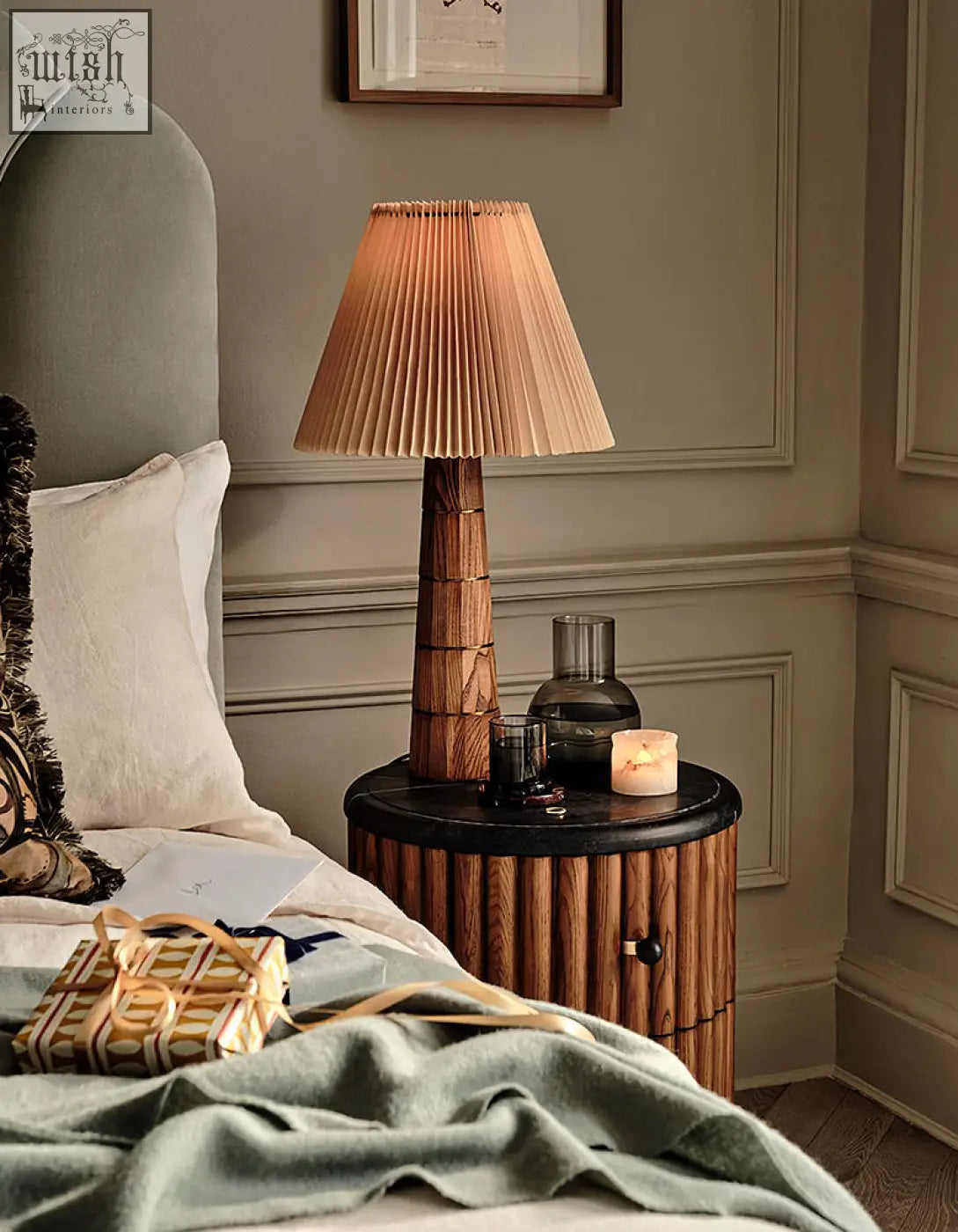 Ava luxe round bedside table with warm toned pleated lampshade on textured wooden base and marble top