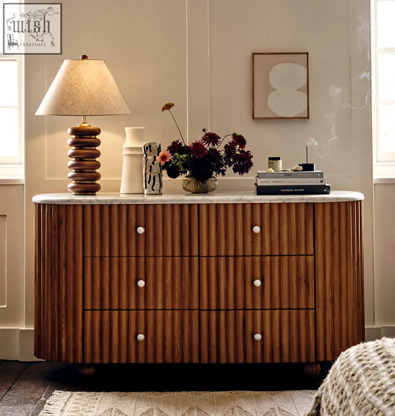 A warm-toned solid wood ava marble hallway sideboard with vertical ribbed detailing and marble surface top with white knobs