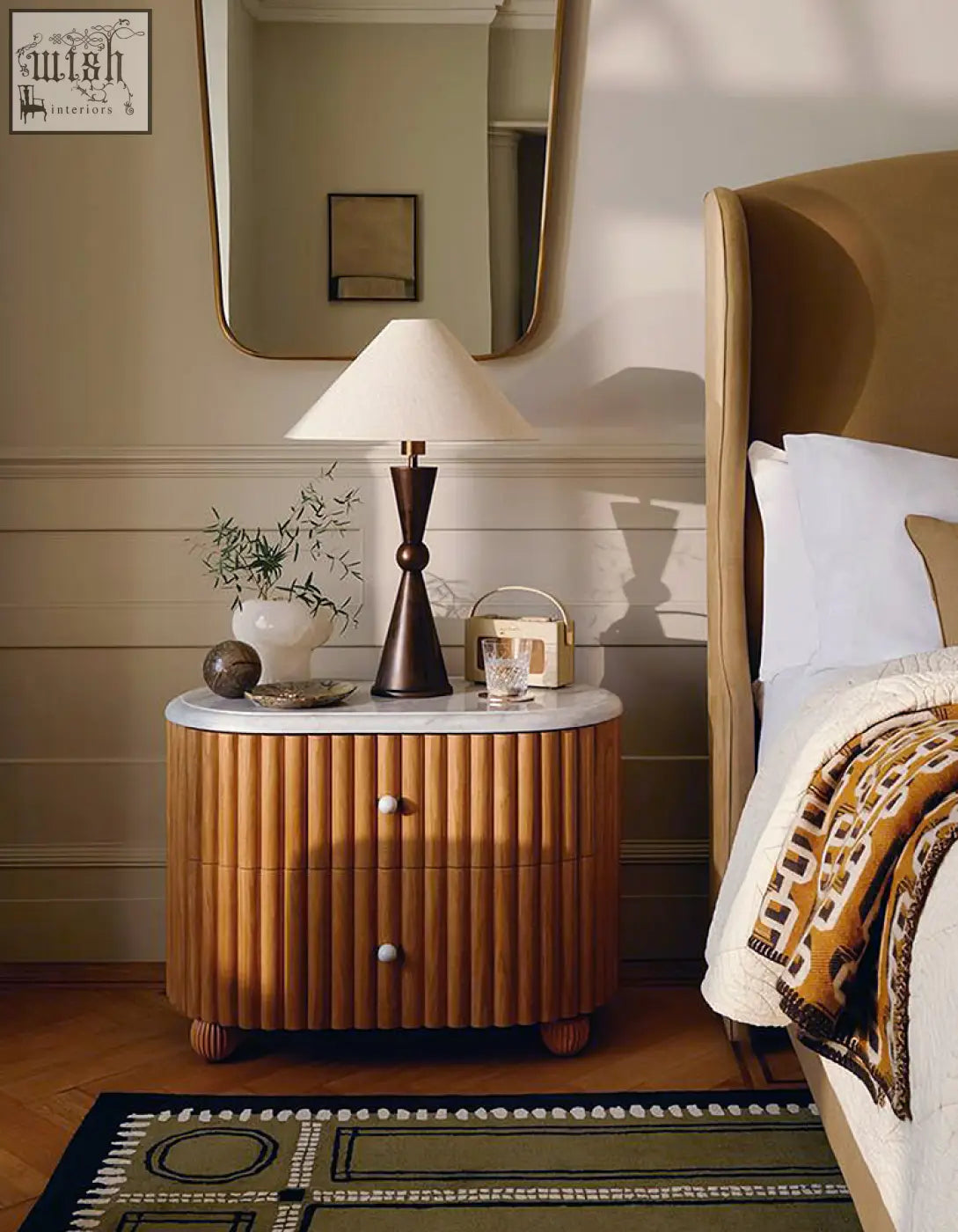 Ava rounded rectangle bedside table with a sleek curved wooden base and white marble top bedside table