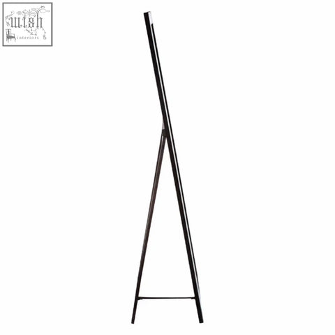 Avelene tall floor standing mirror features bevelled corners with a sleek black metal tripod stand and minimalist design