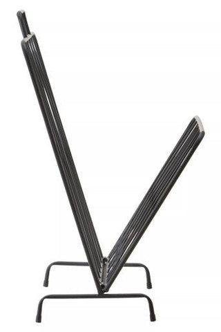 Avento black magazine rack with v-shaped design and four curved legs in sturdy black metal for stylish storage