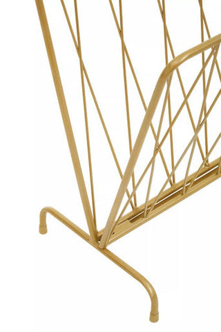 Avento gold finish magazine rack featuring a gold-colored wire geometric lattice design for stylish storage