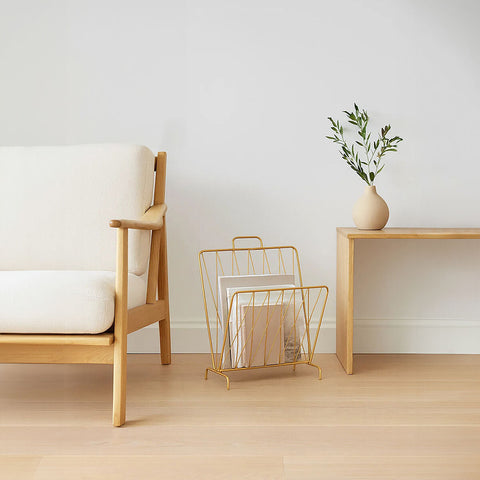 Avento gold finish magazine rack with minimalist geometric design made of gold wire for stylish storage